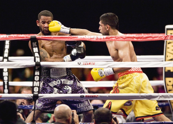 Khan hits Peterson during the third round of their WBA super lightweight and IBF Junior welterweight title fight in Washington