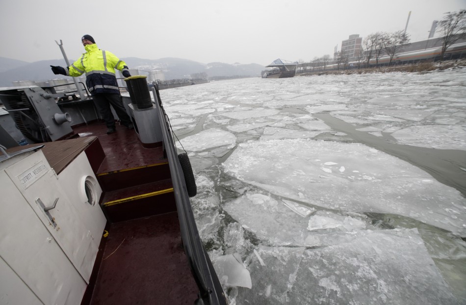 Kronsteiner, an official of harbour authority watches as the icebreaker boat makes its way through frozen Danube harbour in Linz