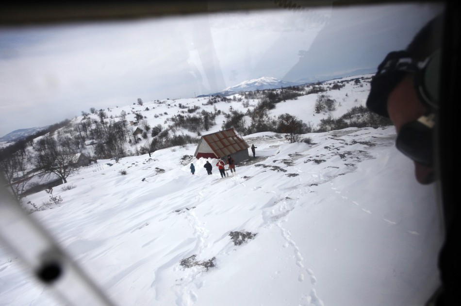 A helicopter pilot tries to land during an emergency evacuation in the isolated village of Donji Drezen during winter in eastern Bosnia