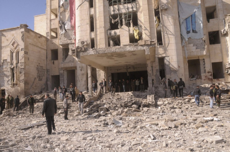 Syrian security personnel inspect the site of an explosion in Syria's northern city of Aleppo