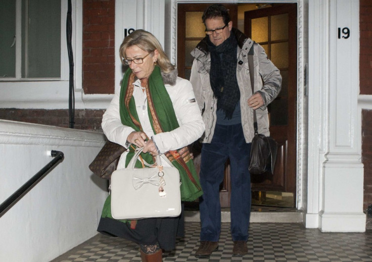 Former England football manager Fabio Capello leaves his Belgravia home with his wife Laura, the morning after resigning his post