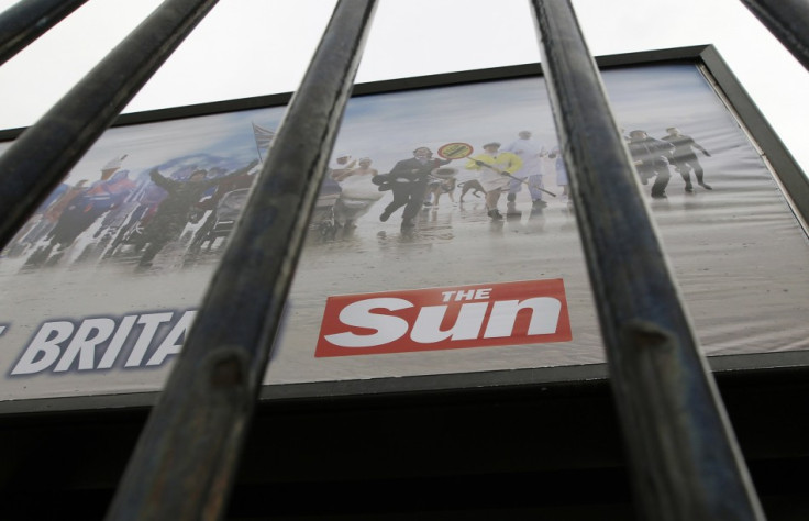 An advertisement for The Sun newspaper is seen on a billboard outside News International's Wapping headquarters in London on Jan. 28, 2012.