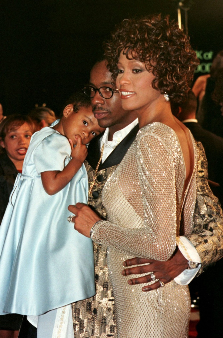 Whitney Houston and Bobby Brown posing with a young Bobbi Kristina