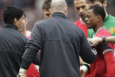 Manchester United's Evra reacts after Liverpool's Suarez ignored his handshake before their English Premier League soccer match in Manchester