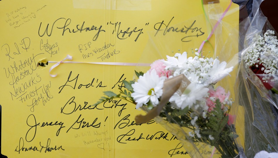 Messages are left for Whitney Houston at a makeshift memorial in front of The New Hope Baptist Church in Newark