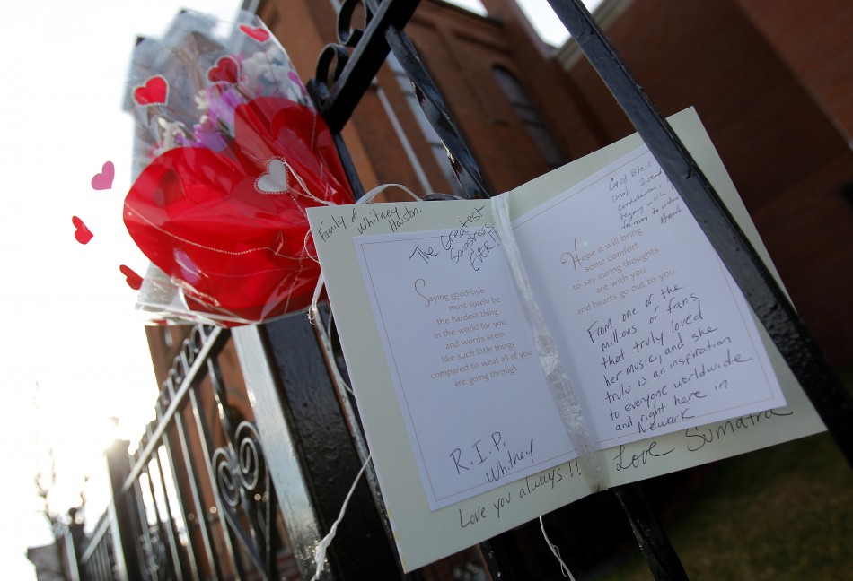 Flowers and a card are seen left as a memorial to deceased singer Whitney Houston, in front of the New Hope Baptist Church in New Jersey