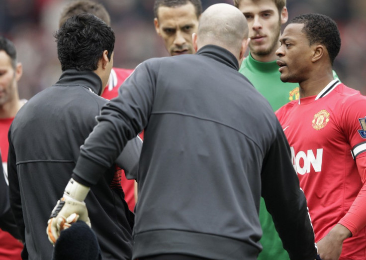 Partice Evra reacts to Luis Suarez&#039;s snub in the handshake line on Saturday.