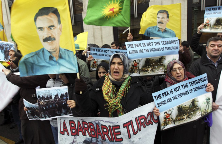 Kurdish demonstrators shout slogans and hold flags with portraits of jailed PKK leader Ocalan during a protest