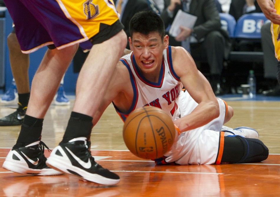 New York Knicks point Jeremy Lin controls loose ball against Los Angeles Lakers in NBA game in New York