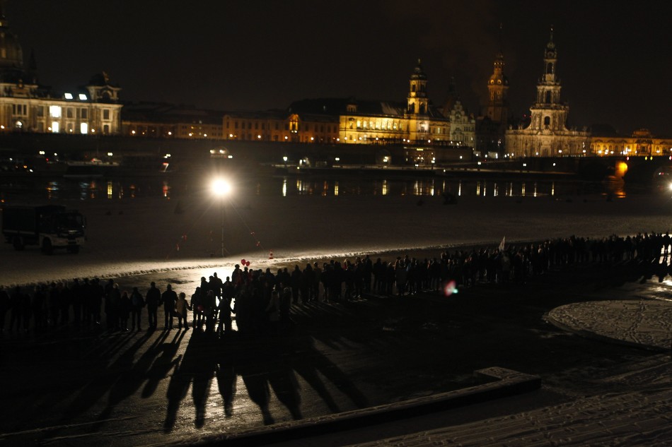 People build a human chain at the river Elbe in Dresden to protest against an Ultra-right activists march through the city centre