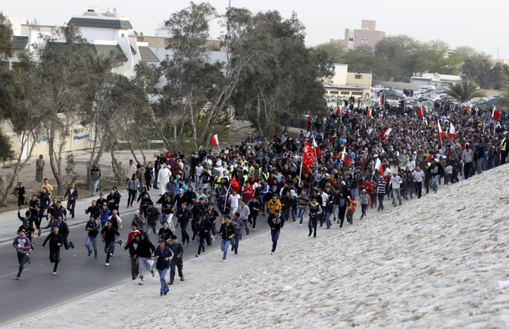 Pro-democracy protesters run towards Farooq Junction during protest in Manama