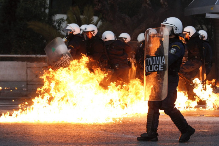 Petrol bomb explodes near riot police during huge anti-austerity demonstration in Athens