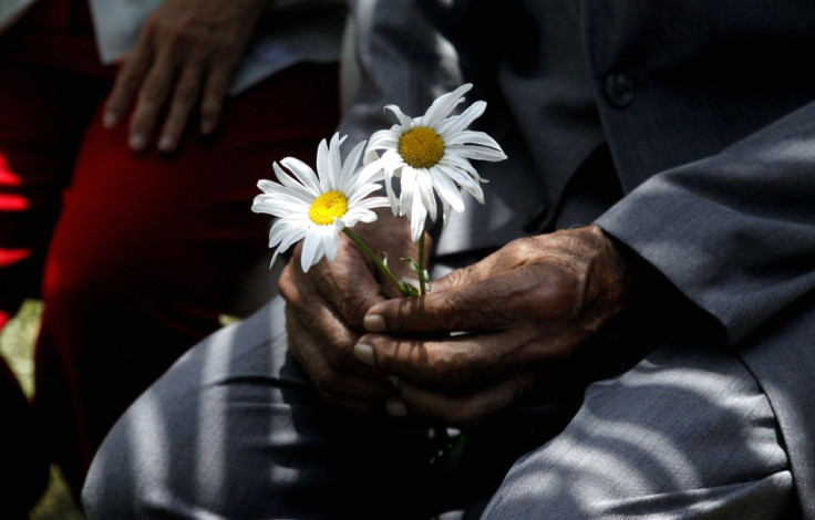 An elderly man holds flowers during Saint Valentine's Day celebrations