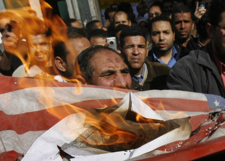 Egyptian demonstrators burn a U.S. flag