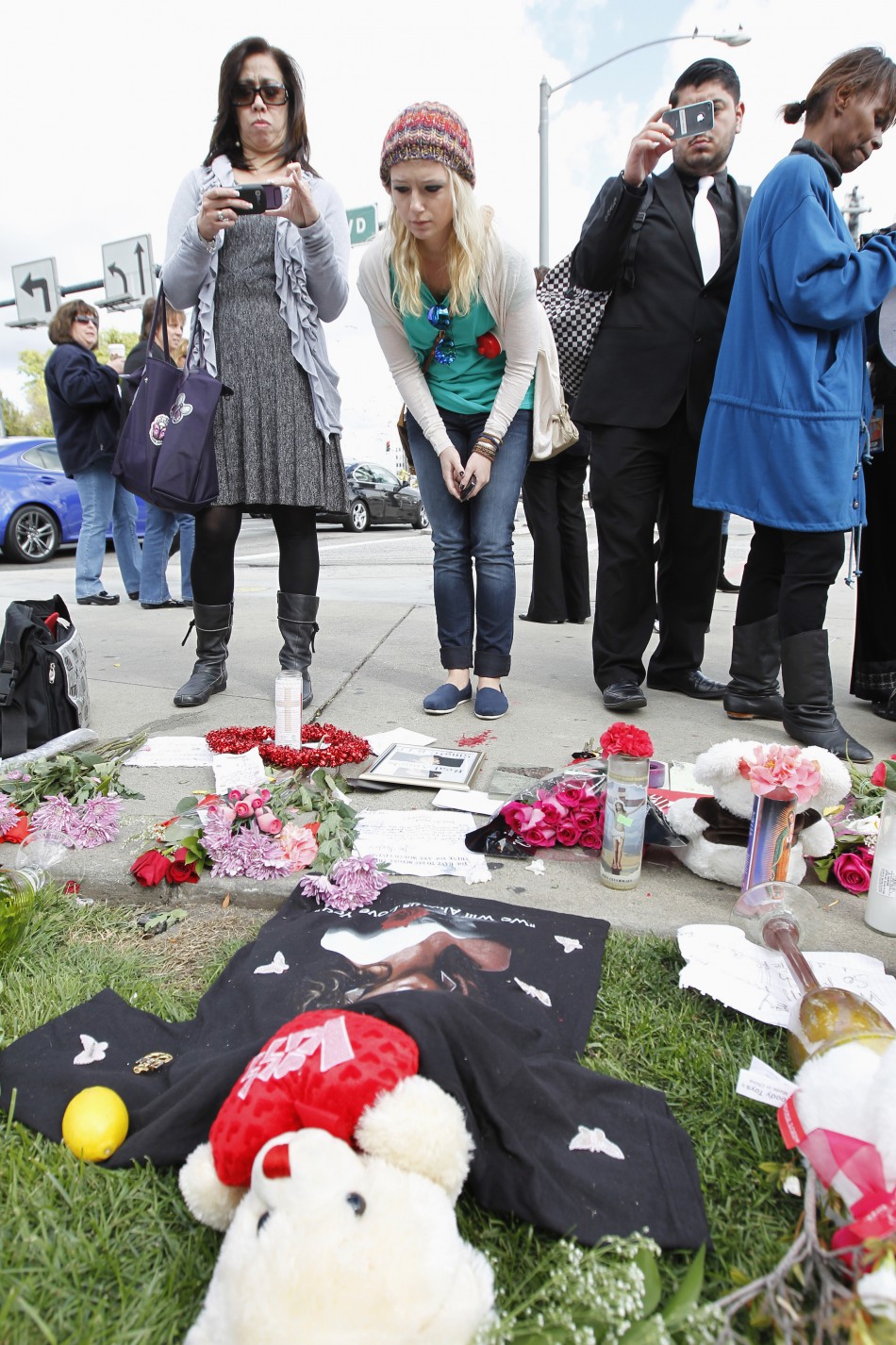 Fans gather at a makeshift memorial to singer Whitney Houston at a corner of the Beverly Hilton Hotel
