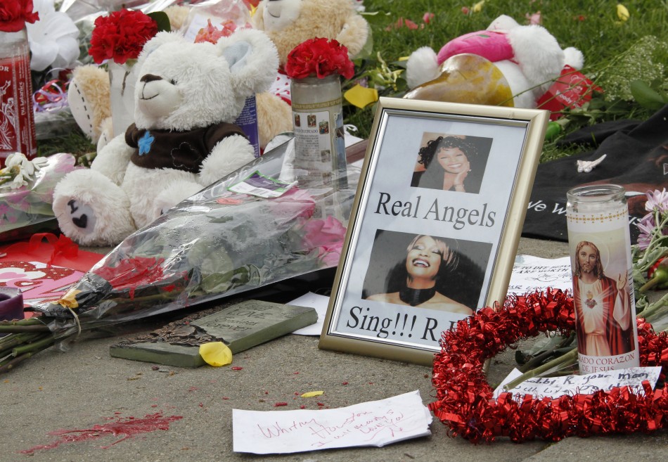 Flowers, a teddy bear and photographs of the late singer Whitney Houston are pictured at a makeshift memorial to her at a corner of the Beverly Hilton Hotel