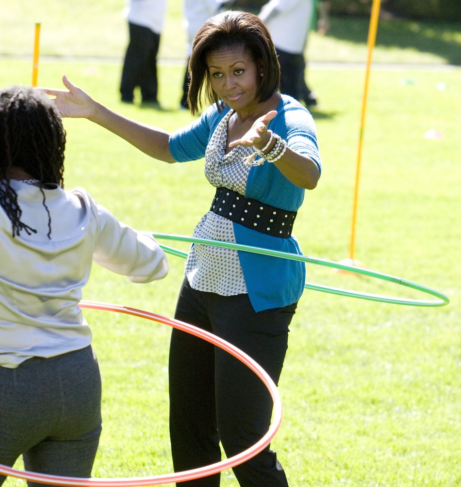 U.S. first lady Michelle Obama hula hoops at Healthy Kids Fair on South Lawn of the White House in Washington