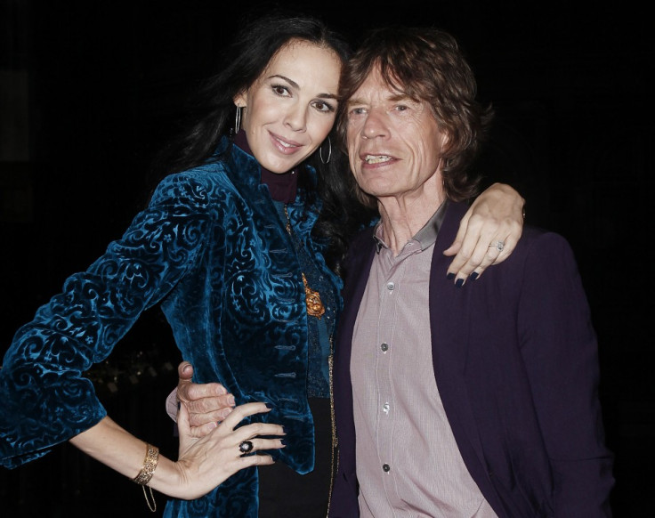 Musician Mick Jagger and designer L'Wren Scott pose following her Fall/Winter 2012 collection during New York Fashion Week, February 16, 2012.