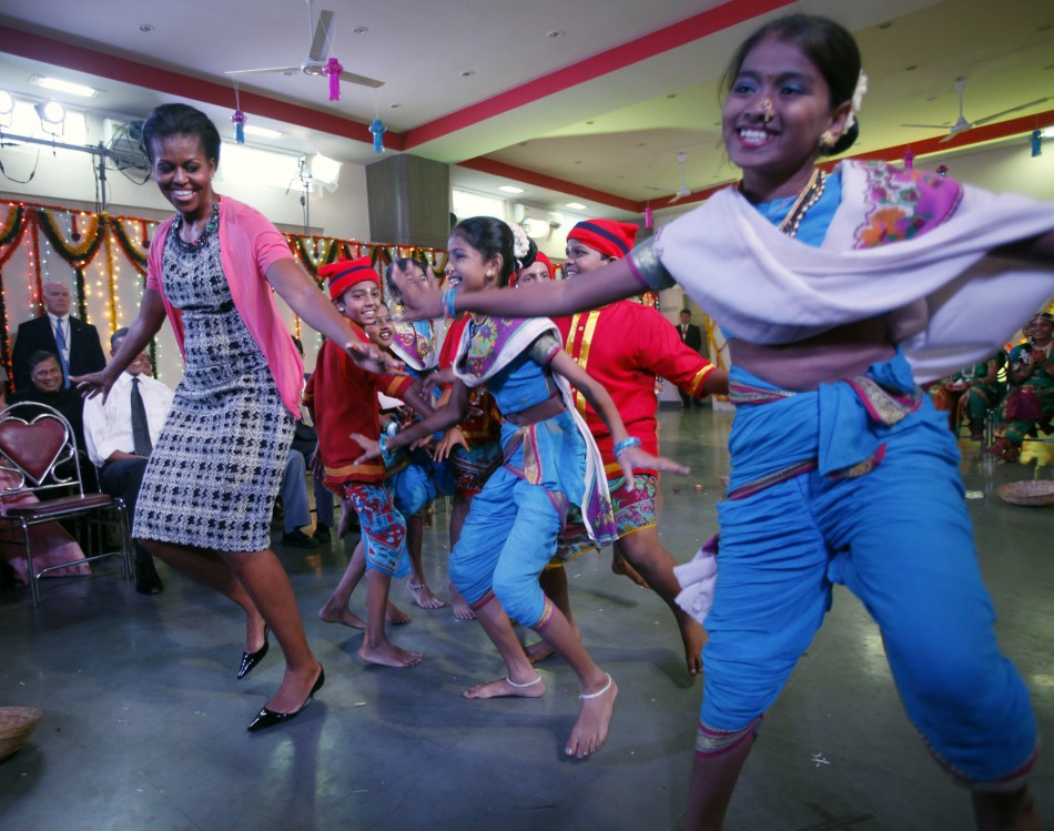 U.S. first lady Michelle Obama dances at the Holy Name High School in Mumbai