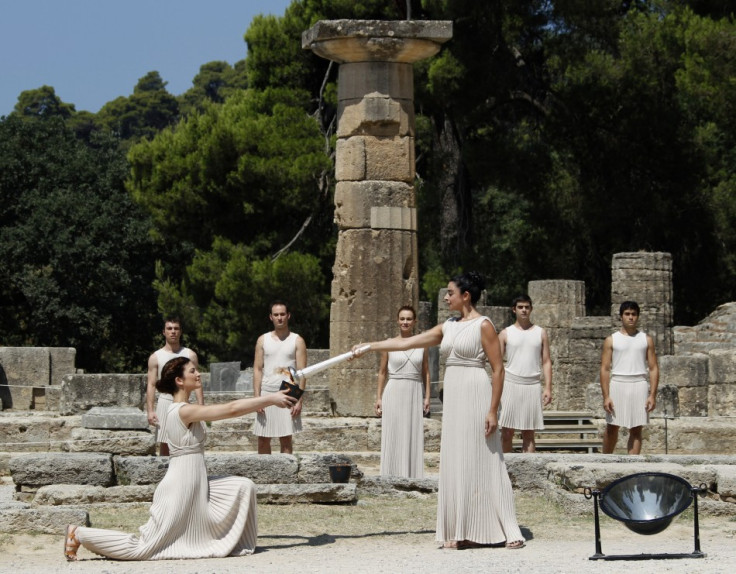 Greek actress Menegaki, playing the role of High Priestess, lights a cauldron during a ceremony in ancient Olympia