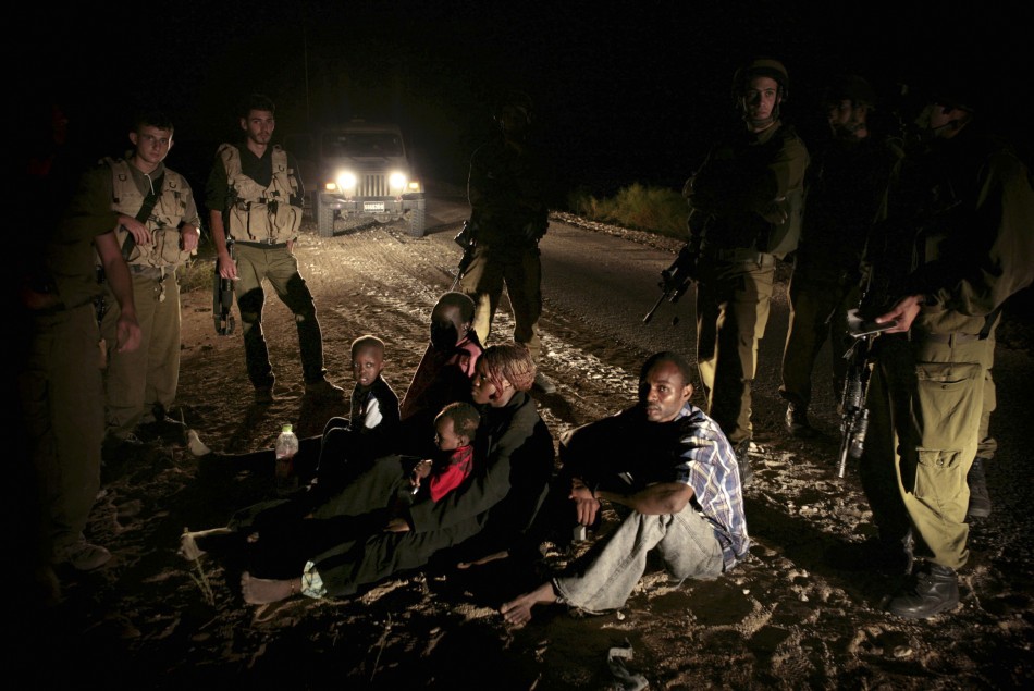 Sudanese refugees who crossed into Israel illegally are detained near Nitzana Sudanese refugees who crossed into Israel illegally are detained near Nitzana