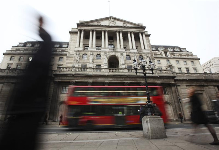 Pedestrians pass The Bank of England in the City of London