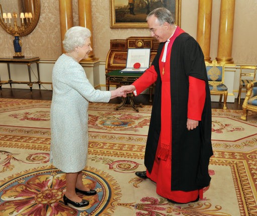 Queen Elizabeth II shakes hands with the Dean of Westminster Abbey Dr John Hal
