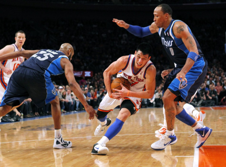 New York Knicks point guard Jeremy Lin drives to the basket between Dallas Mavericks forward Shawn Marion (R) and guard Vince Carter in the second half of their NBA basketball game at Madison Square Garden in New York, February 19, 2012.