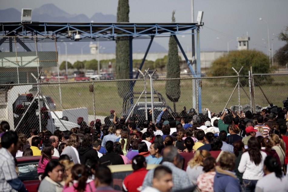 Relatives of inmates wait for news of their relatives outside the state prison in Apodaca