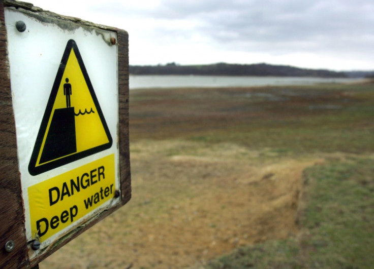A sign warning of deep water is seen some distance from the water's edge at Bewl Reservoir, Kent (Reuters)