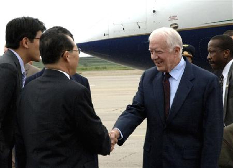 Former U.S. President Jimmy Carter shakes hands with Kim Kye-gwan, Vice Foreign Minister of North Korea, upon his arrival at Sunan airport in Pyongyang