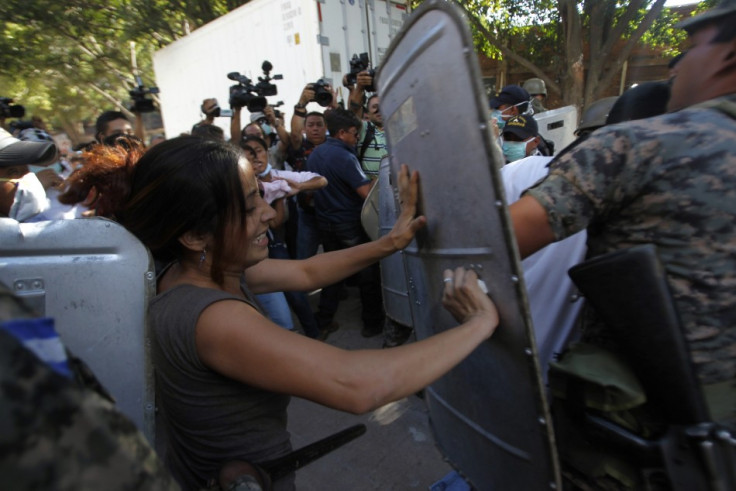 Relatives of the prison fire victims clash with police as they try to enter a morgue to identify bodies (Reuters)