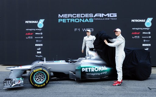 Michael Schumacher of Germany, right, and Nico Rosberg of Germany uncover the new F1 W03 during the official presentation of Mercedes GP Formula one team 2012 at the Montmelo racetrack near Barcelona, Spain, Tuesday, Feb. 21, 2012