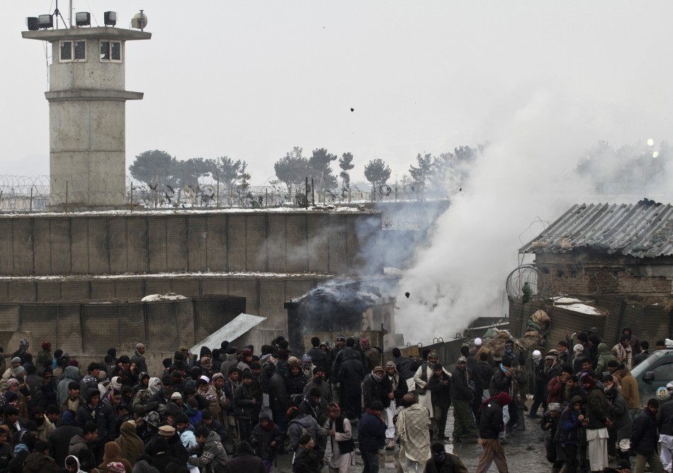 Afghan men gather as some of them throw rocks towards the U.S. military base during a protest in Bagram Afghan men gather as some of them throw rocks towards the U.S. military base during a protest in Bagram