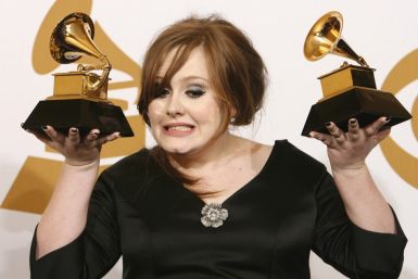 Adele holds her awards for Best New Artist and Best Pop Vocal Album