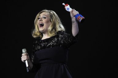 Adele reacts as she holds her award for best British album of the year during the BRIT Music Awards at the O2 Arena in London