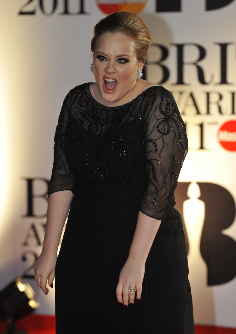 Adele Adkins poses for photographers at the BRIT music awards at the O2 Arena in London