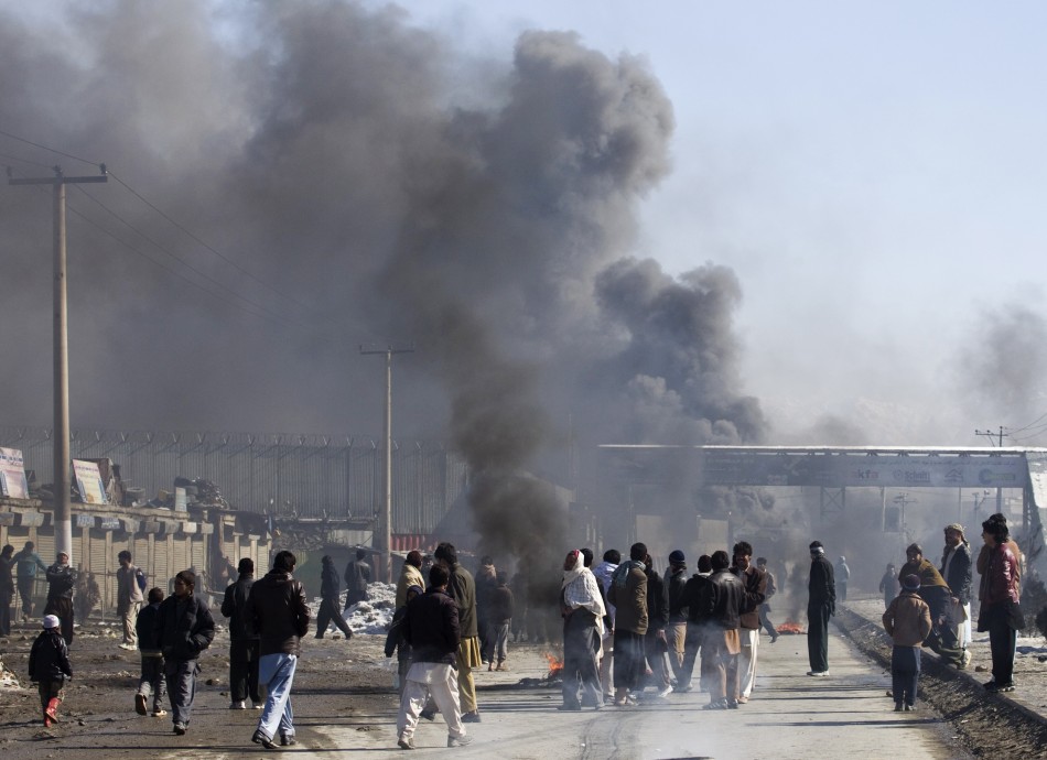 Smoke rises from part of a base belonging to foreigner during a protest in Kabul