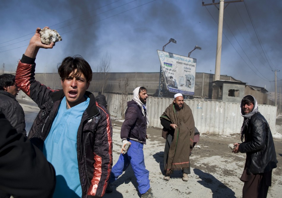 Afghan protesters hold rocks during a protest near a U.S. military base in Kabul