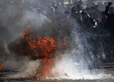 Fuel burns as Afghans protest near a U.S. military base in Kabul Fuel burns as Afghans protest near a U.S. military base in Kabul