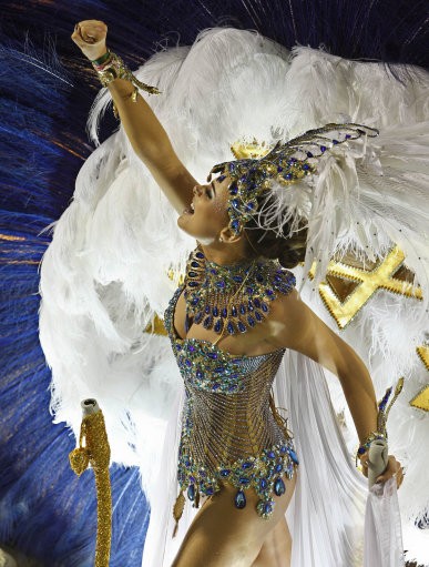 A dancers of Grande Rio samba school parades on a float during carnival celebrations at the Sambadrome in Rio de Janeiro, Brazil, Tuesday, Feb. 21, 2012.