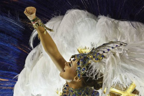 A dancers of Grande Rio samba school parades on a float during carnival celebrations at the Sambadrome in Rio de Janeiro, Brazil, Tuesday, Feb. 21, 2012.