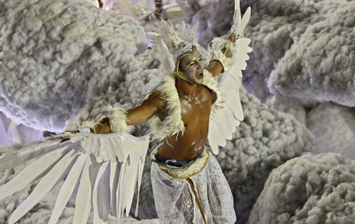 A dancer of Grande Rio samba school parades on a float during carnival celebrations at the Sambadrome in Rio de Janeiro, Brazil, Tuesday, Feb. 21, 2012. Nearly 100,000 paying spectators turn out for the all-night spectacle at the Sambadrome