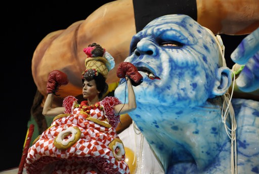 A performer from the Grande Rio samba school parades during carnival celebrations at the Sambadrome in Rio de Janeiro, Brazil, Tuesday, Feb.21, 2012. Nearly 100,000 paying spectators turn out for the all-night spectacle at the Sambadrome