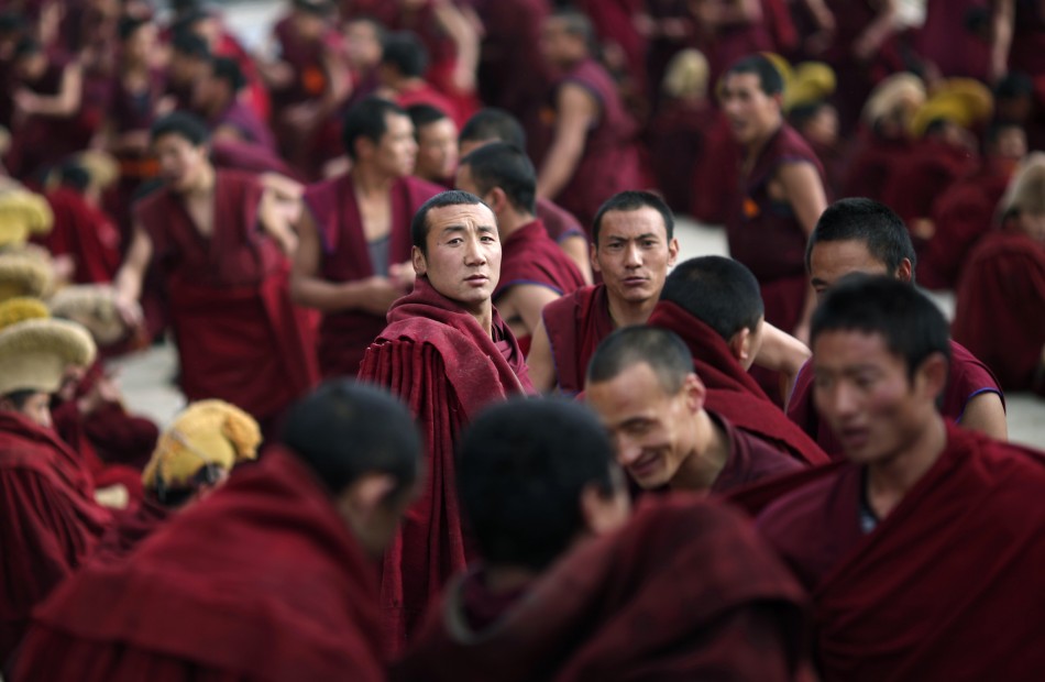 Monks gather outside a temple during Tibetan New Year celebrations in Langmusixiang