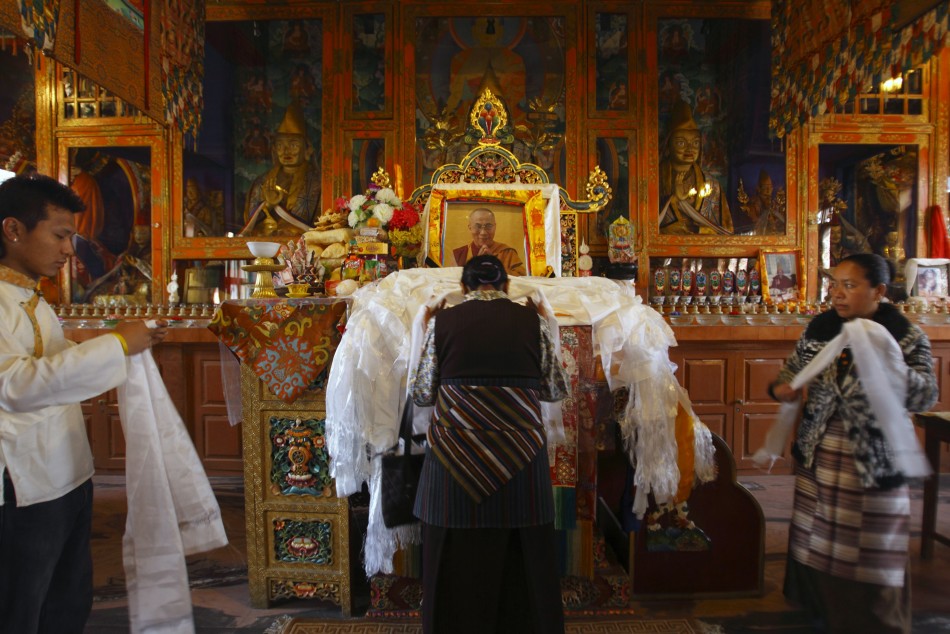 Tibetans offer prayer in front of the portrait of their spiritual leader Dalai Lama during the first day of New Year or quotLosarquot in Kathmandu