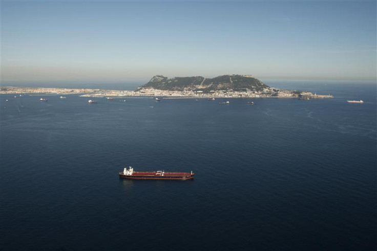 Aerial view shows a merchant marine ship sailing past the Rock of Gibraltar in the Strait of Gibraltar