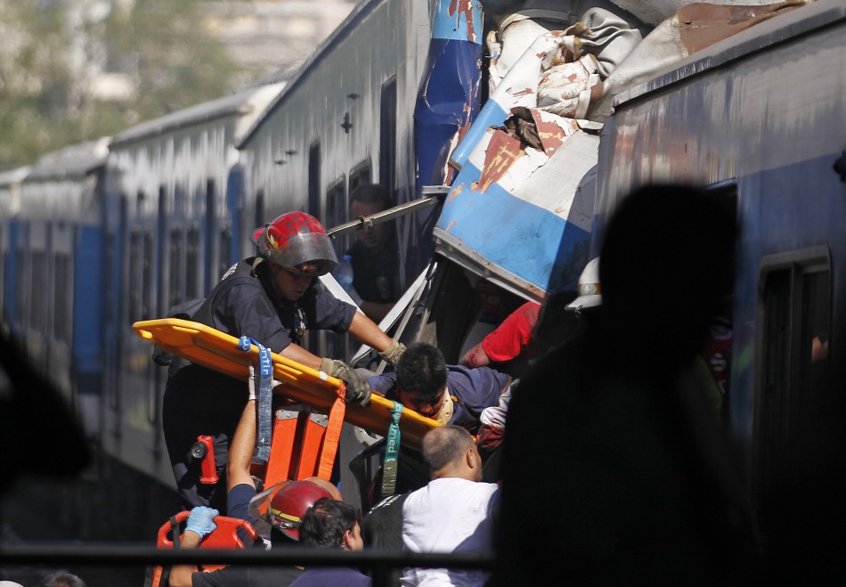Rescue workers extract a passenger from a commuter train that crashed into the Once train station at rush hour in Buenos Aires (Reuters)