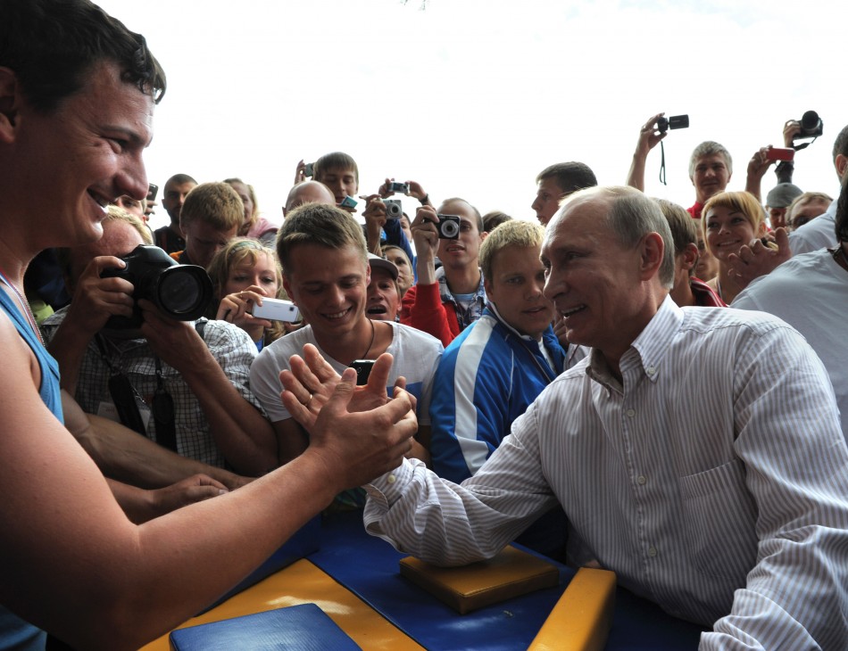 Russian Prime Minister Vladimir Putin R arm-wrestles Nashi