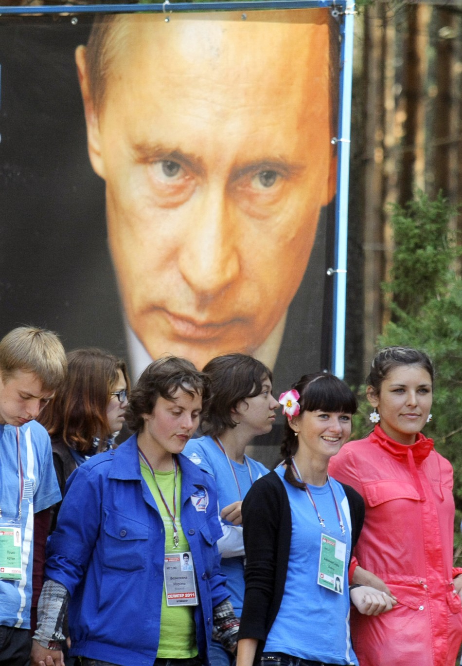 Participants pass a poster of Russian Prime Minister Vladimir Putin during his visit to the summer camp of the pro-Kremlin youth group quotNashiquot